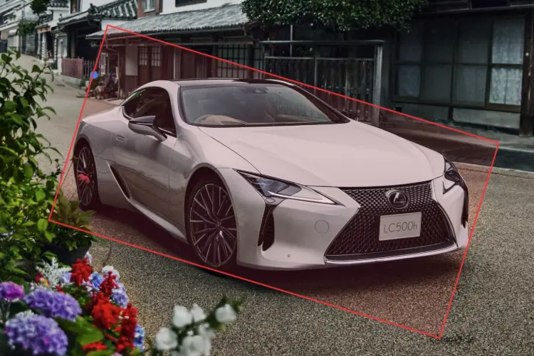 A car annotated with a rotated box at an angle, showing 8 aligned resize handles and a curved-arrow rotation handle on a short stem above the top edge